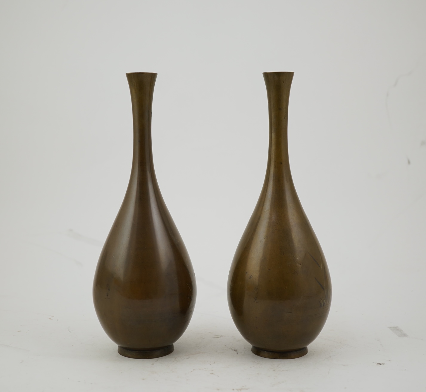 A pair of Japanese bronze and mixed metal inlaid bottle vases, signed Hidemitsu, Meiji period
